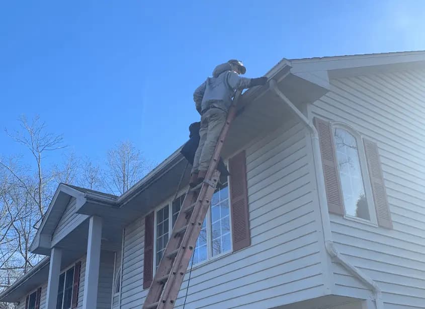 Gutter cleaning and maintenance being performed by Kent Power Washing in Kent